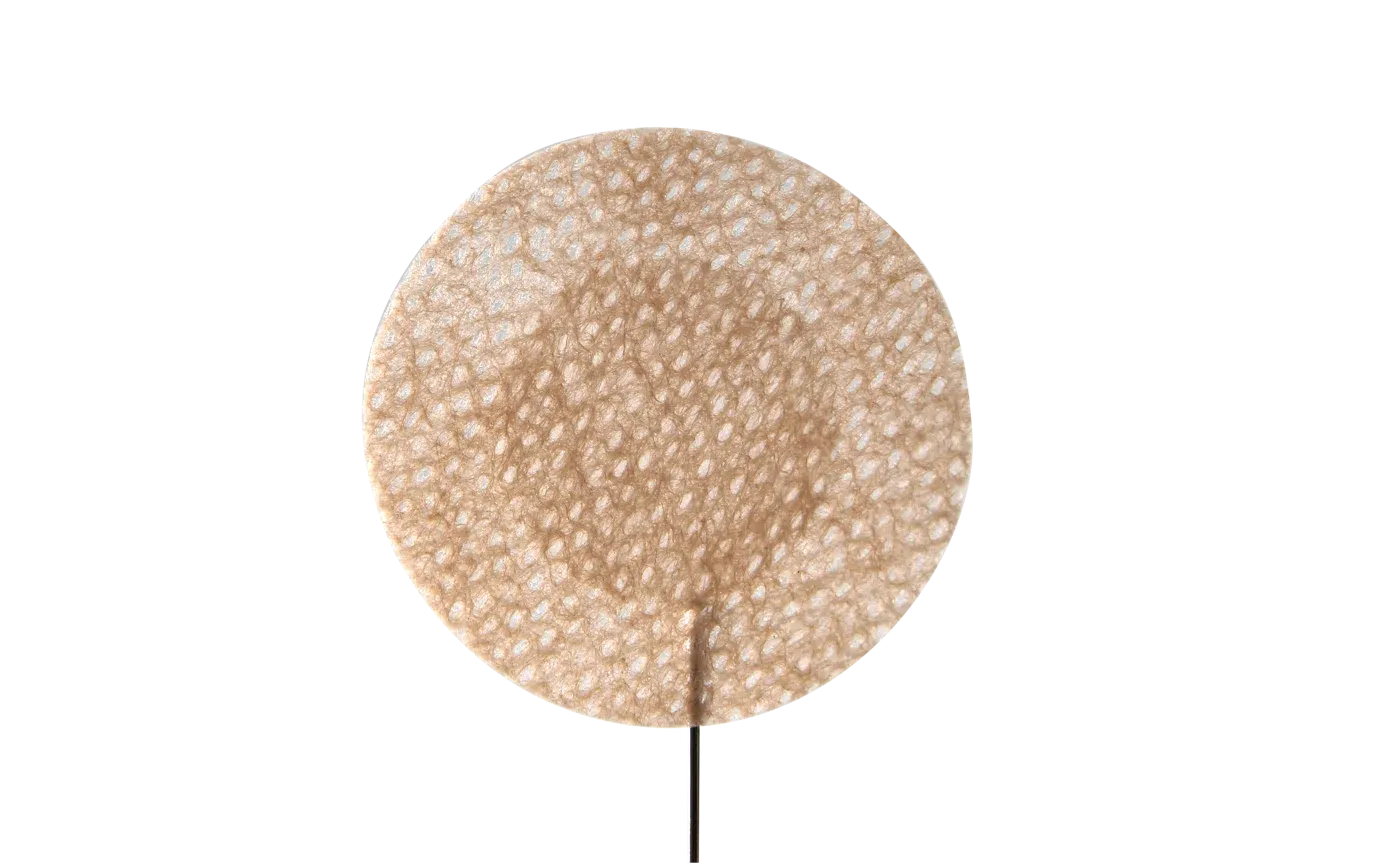 Close-up of a round nipple cover showing the soft center pad and the adhesive ring around it